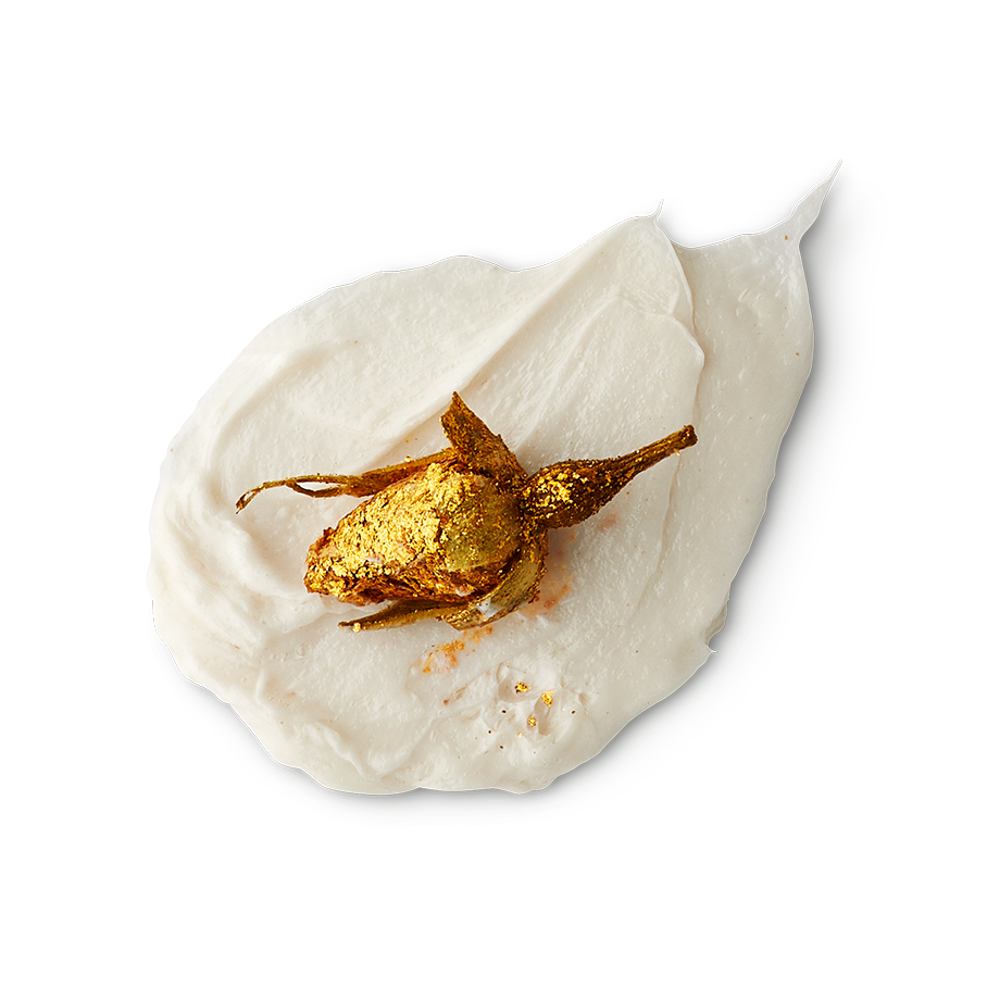 Posh White Chocolate and Roses. A neatly smudged swatch of thick, creamy body wash with an unopened flower bud dipped in gold glitter on top.